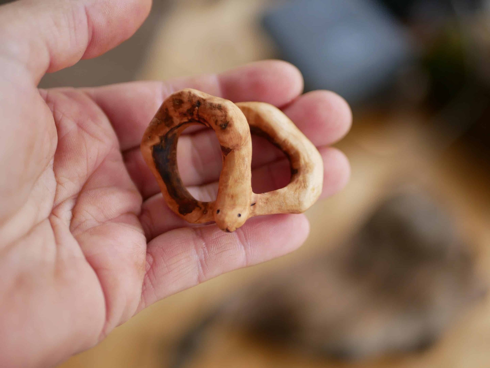 Handschmeichler in Schlangenform aus einer Baumperle