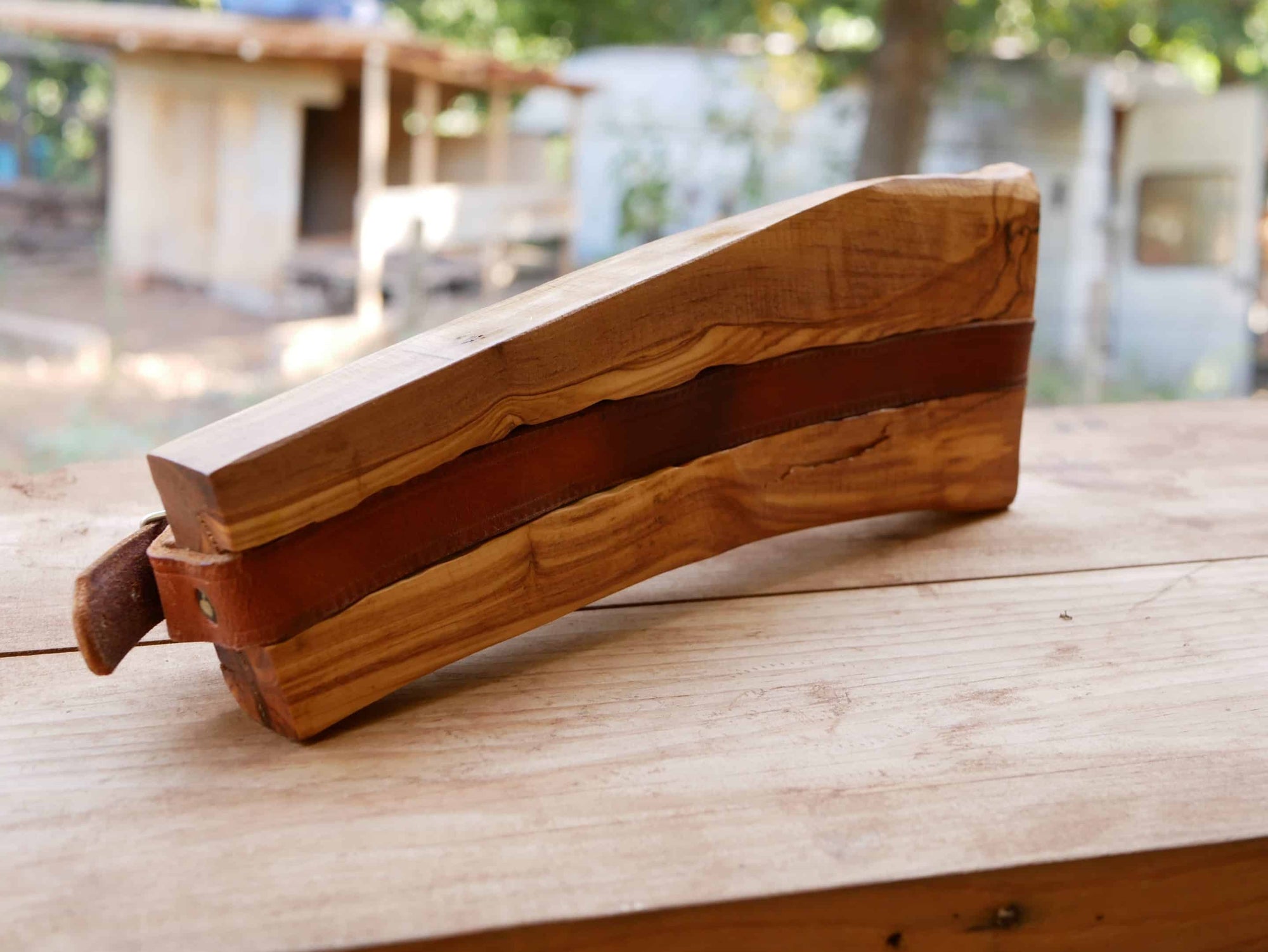 Rustikaler Kabelhalter aus Olivenholz und einem alten Gürtel