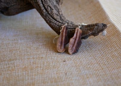 Ohrringe aus Baumperle als Feder geschnitzt