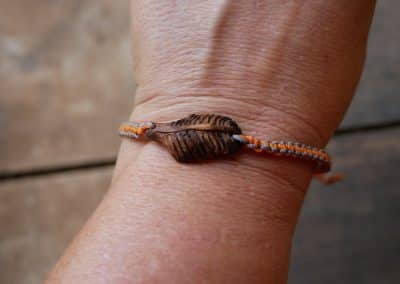 Makramee Armband mit einer Baumperle als Feder geschnitzt